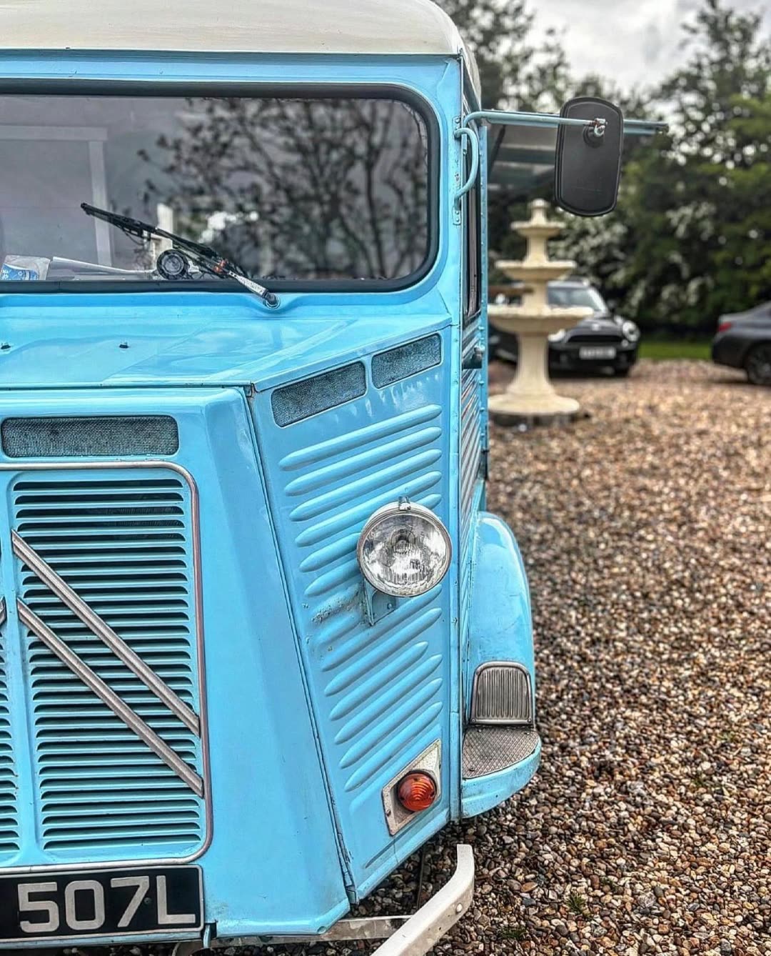 Pizza On The Go van set up in a garden estate with a fountain