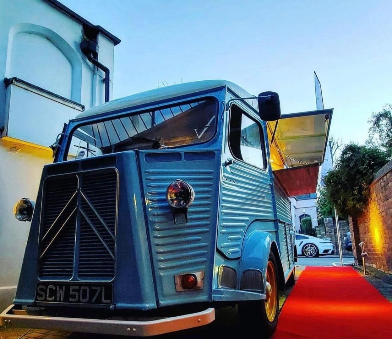 Pizza On The Go van arriving on a red carpet at a wedding venue